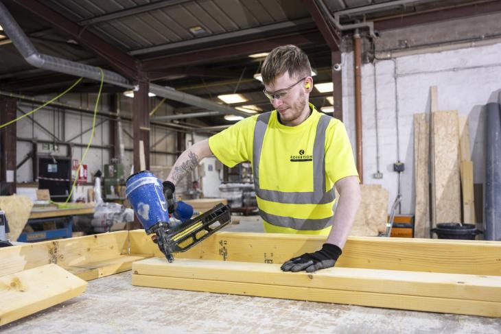 Robertson Timber Engineering employee nailing a timber frame at the Elgin Factory