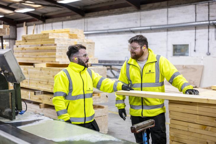 Two timber engineering employees in timber manufacturing facility