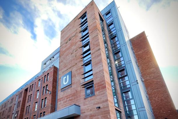 Red-bricked student accommodation in Glasgow with bright blue skies