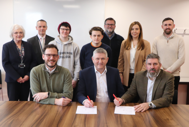 Robertson Group and Edinburgh College individuals sat at a table signing a Memorandum of Understanding