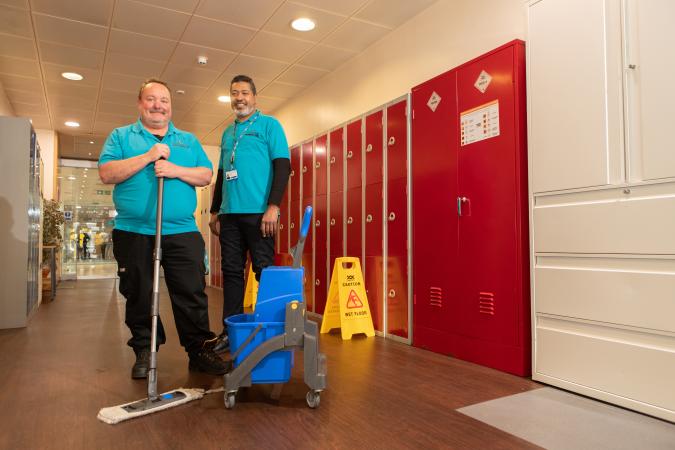 Two employees from Robertson Facilities Management, with mop and bucket 