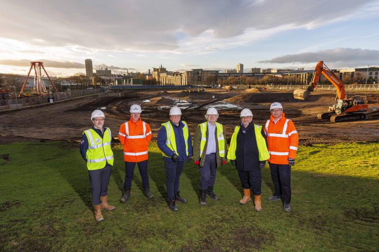 Six people standing on site at Aberdeen Beachfront, being delivered by Robertson Construction