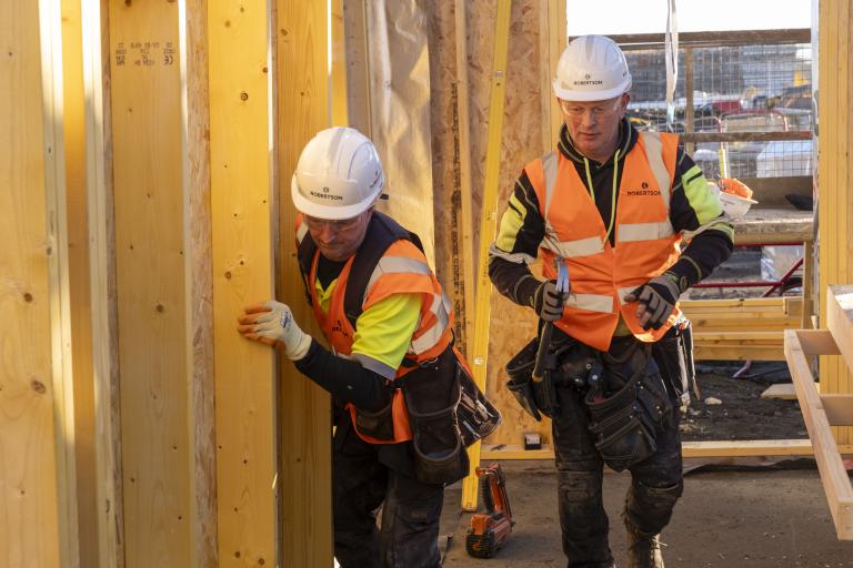 Two Robertson Timber Engineering employees working at the Lovell Partnerships' development