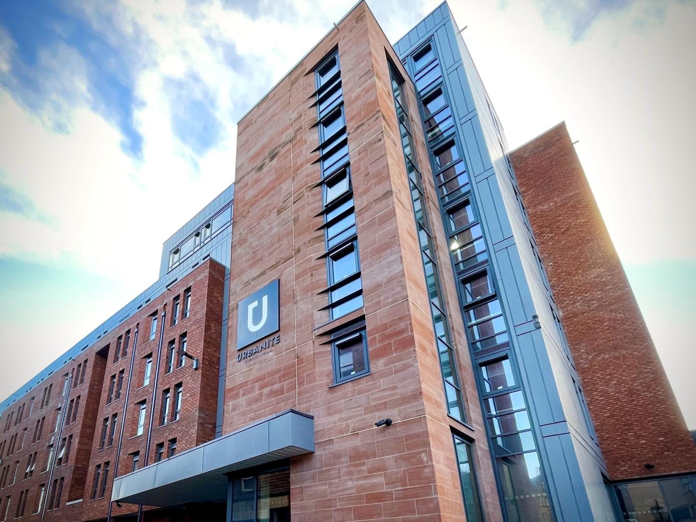 Red-bricked student accommodation in Glasgow with bright blue skies