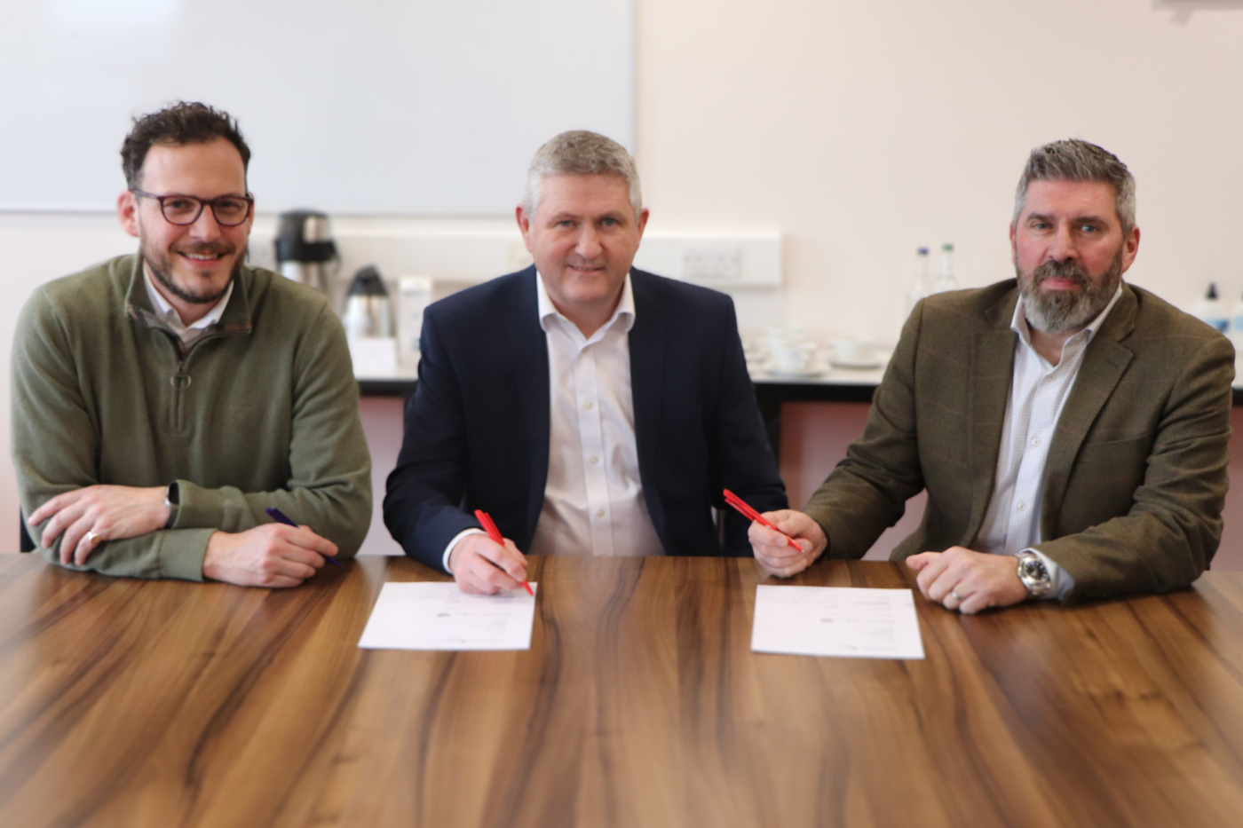 Robertson Group and Edinburgh College principals sat at a table signing a Memorandum of Understanding